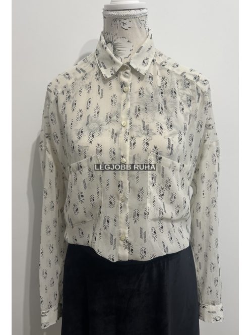 Hosszú ujjú elegáns szabású, ingblúz, anyagában absztrakt mintázattal, a mellénél zsebekkel.